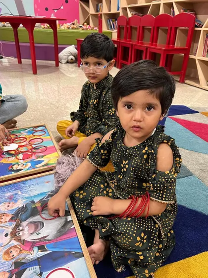 Two friends in their festive outfits enjoying the activities. Diwali at The Reading Room is a time for friendship, creativity, and celebration.