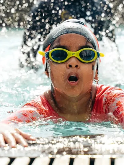 The pure excitement of learning to swim! This close-up shot captures a young swimmer's expression of effort and fun, embodying the positive and memorable experiences we create at our summer camp.