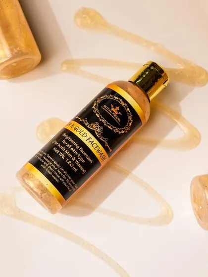 A texture shot of the golden, shimmery face wash gel swirled on a clean white surface. This type of macro shot is perfect for showcasing the unique consistency and ingredients of a skincare product.