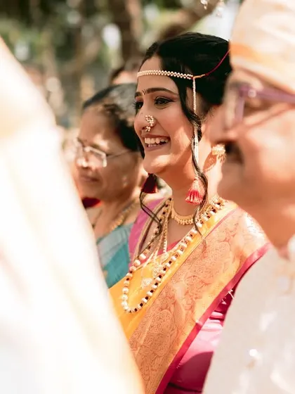 A candid shot of the bride's happy smile as she sees her groom for the first time at the ceremony.