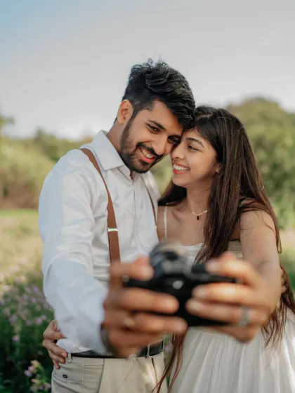 A fun selfie moment during the shoot. It’s a modern and relatable way to capture the couple's personality.