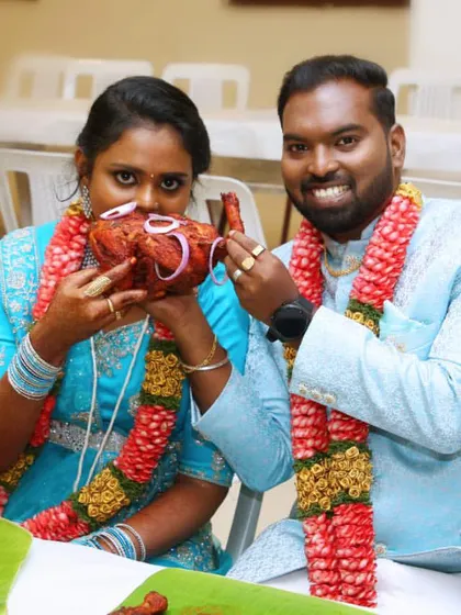 A special moment for the newlyweds, enjoying a taste of our specially prepared chicken. We ensure the couple is treated like royalty on their big day.