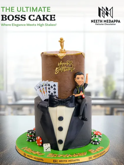 The ultimate boss cake! This two-tiered creation combines a sharp tuxedo design with a casino theme, including cards, chips, and a roulette wheel topper.