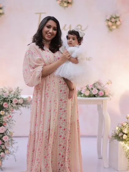 A mother and daughter share a sweet moment at a beautifully styled floral-themed party.