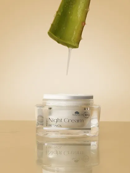 This image for Natuos 365 Night Cream demonstrates a key ingredient, aloe vera, with a drop of gel falling onto the jar. This is a powerful visual storytelling technique to highlight natural formulations.