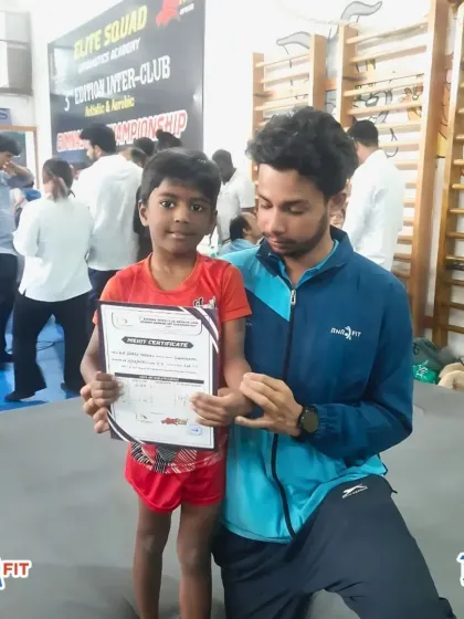 Another proud winner with his coach after a successful competition. The bond between our coaches and gymnasts is key to their growth and success.