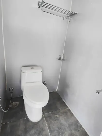 A look inside the attached washroom of one of our prefab rooms, featuring modern fixtures and a clean, minimalist design.