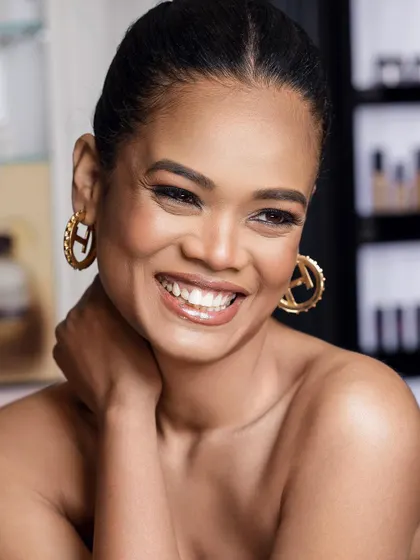 A joyful, smiling portrait from our collaboration with Bobbi Brown. This image captures a moment of genuine happiness, associating the brand with confidence and natural, radiant beauty.