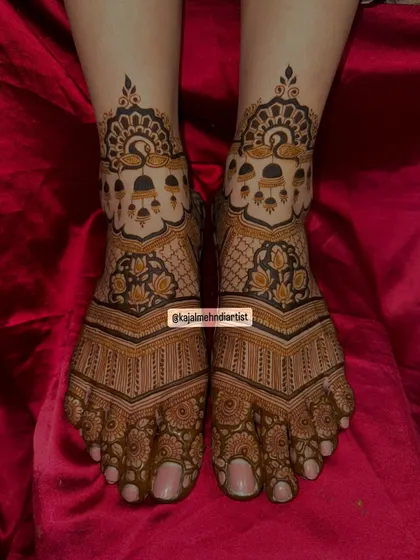 A top-down view of the peacock and bells foot henna, showcasing the perfect symmetry.