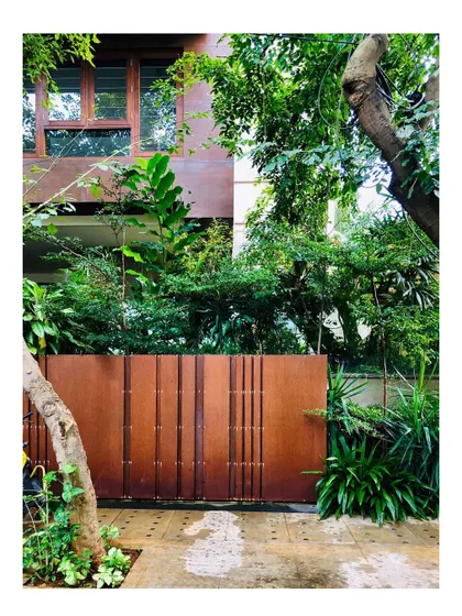 The Corten steel gate of Kanasu, designed to age beautifully and blend with the natural, earthy tones of the home and its landscape.