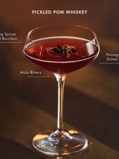 Our bestselling Pickled Pom Whiskey. It features a pickling spice-infused bourbon, balanced with a pomegranate salted shrub and a hint of mole bitters.