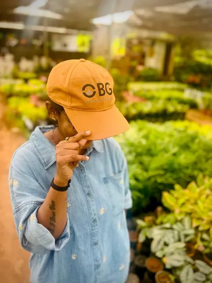 A picture of me at the nursery, proudly wearing our branded OBG cap. We believe in our brand and the value we bring to making spaces beautiful and green.