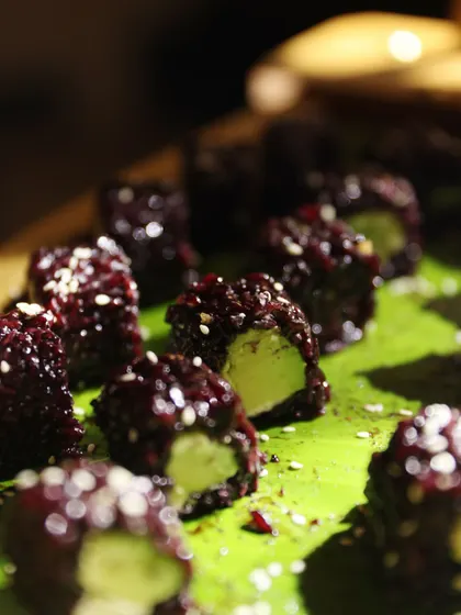 A unique creation of beetroot-cured rice with an avocado center, sprinkled with sesame seeds. This dish showcases our innovative use of ingredients and our flair for creating visually stunning appetizers.