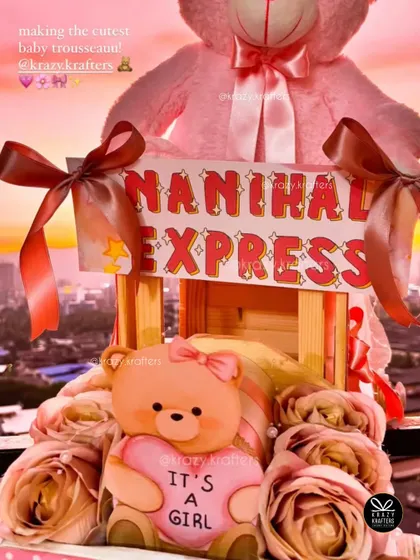 A beautiful shot of the 'Nanihaal Express' trousseau against a sunset backdrop, highlighting the 'It's a Girl' teddy bear.