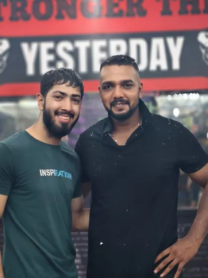 A friendly moment with a student. The gym is a place for serious training, but also for building friendships.