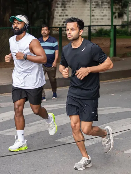 Focused and in sync. Two of our runners maintaining a strong pace during a weekend group run.