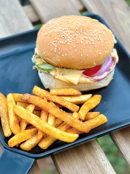Our Cheese Melt Burger with a side of peri-peri fries is a hearty and delicious option from the Think Pawsitive Cafe menu.