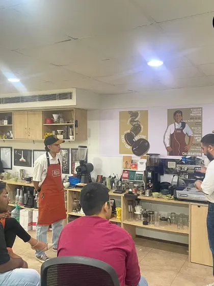 Students observing a demonstration of espresso extraction before the flavor pairing session begins.