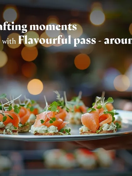 A server holds a platter of smoked salmon canapés, showcasing an elegant appetizer option.