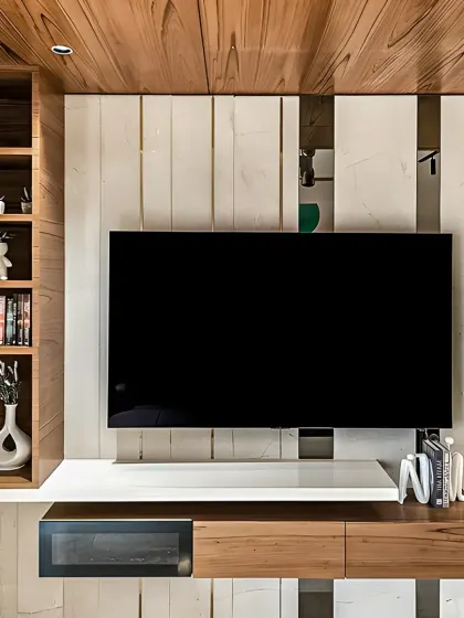 A contemporary TV unit that combines open shelving for decor with closed cabinets for media devices. The mix of wood and white finishes creates a balanced and modern look.