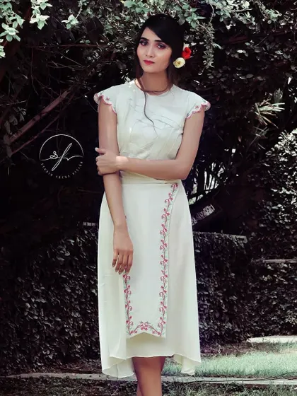 A look from my 'Passage to India' concept shoot, which blends modern silhouettes with traditional Indian details. This white dress features delicate pink embroidery and a contemporary, asymmetrical hemline.