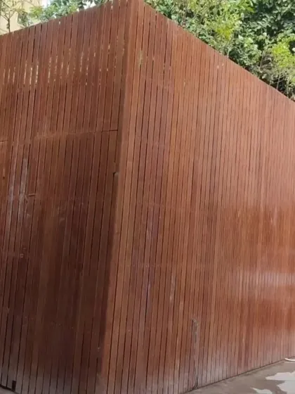 This solid wall is clad entirely in our vertically installed Tipwood, creating a private and fortress-like enclosure. It's a great solution for service blocks or areas requiring complete visual screening.