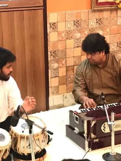 A moment of instruction from my Guruji, Pandit Subhankar Banerjee ji. His guidance on the harmonium, correcting my rhythm and flow, was an integral part of my training.