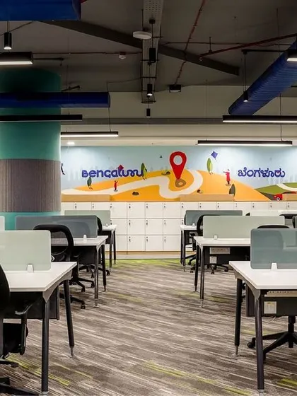 The finished project, bringing our render to life. This photo shows the completed workstation area with the vibrant Bengaluru-themed mural, demonstrating our ability to execute a design vision with precision.