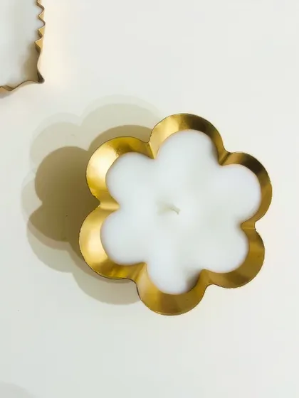 A flower-shaped urli candle, perfect for adding a touch of floral elegance to your decor.
