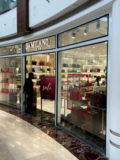 The Da Milano store at Select City Walk, Saket. The glass facade provides a clear view of the brightly lit, luxurious interior.