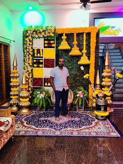 A photo of me with one of our unique housewarming backdrops. I encourage my students to be creative and develop their own signature style.