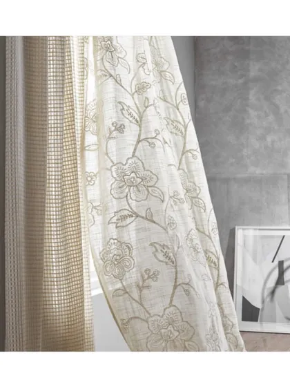 The 'Trafalgar' collection offers a wide range of sheer fabrics, from contemporary to classic styles. This floral embroidered sheer adds a touch of elegance and texture to the window, softening the light and the room's edges.