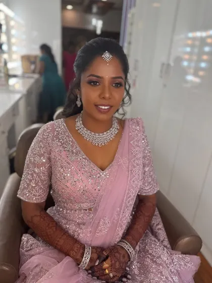A smiling portrait of Surya in the studio. Her makeup is flawless, and she looks absolutely ready for her reception celebration.