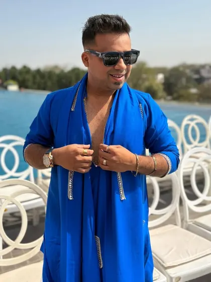 A smile on my face as I get ready to host a poolside Haldi. The beautiful blue water in the background perfectly complements my outfit and the celebratory mood.