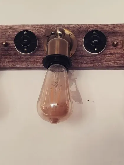 For a more industrial or rustic vibe, I love using custom fixtures like this. A wooden plank with exposed Edison bulbs and vintage-style switches adds a lot of character and warmth to a space.