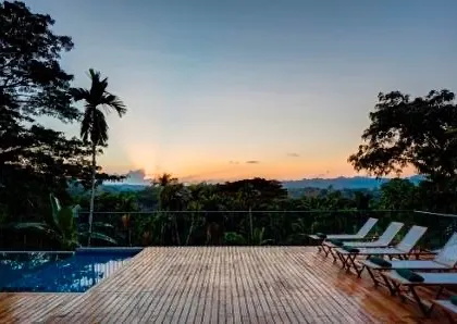 The pool deck at sunset, offering a breathtaking view over the Andaman forest.