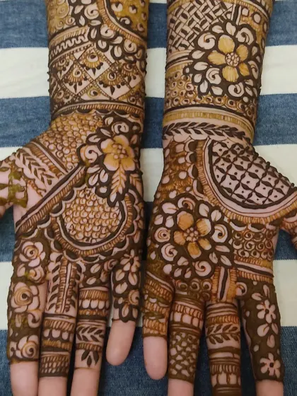 A classic Indian mehendi design with intricate details covering the entire hand and wrist.