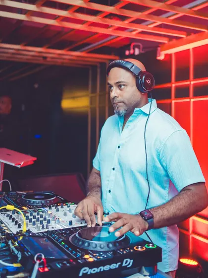 A shot of me working the Pioneer DJ decks during a packed Saturday night. I'm constantly tweaking the mix to keep the energy flowing and the crowd engaged.