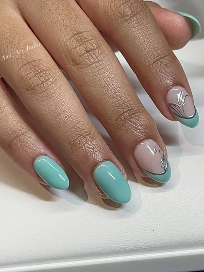 A minty green base with a delicate silver flower design. This is a fresh and elegant look.