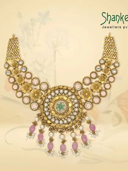 A majestic Kundan-style necklace with a large circular pendant, featuring pink beads and pearls. This piece is a perfect example of our grand, contemporary-traditional fusion designs.
