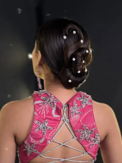 A side profile of the elegant pearl bun, highlighting its clean lines and the way the pearls catch the light.