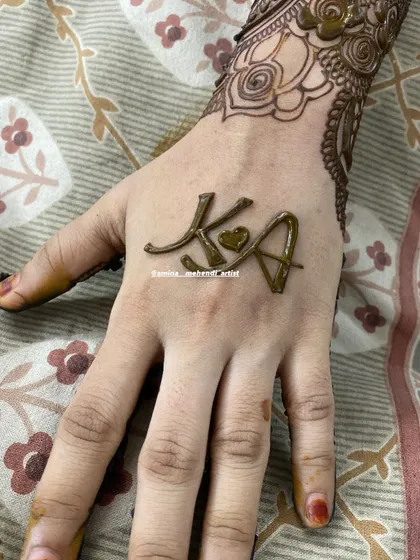 A cute and romantic initial design, connecting the letters 'KA' with a tiny heart in the middle.