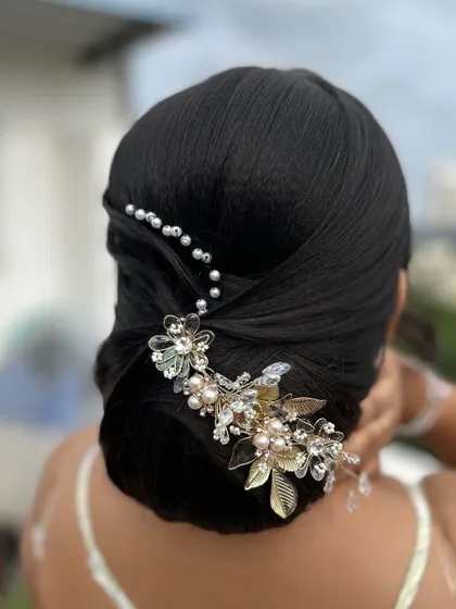 A close-up of the sleek bun and the exquisite hair accessory.