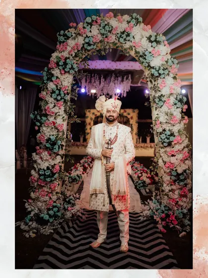 A full view of a groom's wedding attire. I designed this ivory sherwani with a matching turban and a contrasting stole, creating a complete and regal look for his special day.
