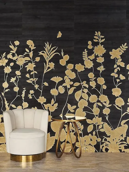 The 'Flourish' collection mural, featuring majestic birds, climbing botanicals, and fluttering butterflies rendered in shimmering gold leaf on a dark wood veneer. This design transports you to a serene and luxurious garden landscape.