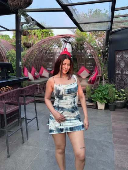 Posing in the eye-catching printed dress.