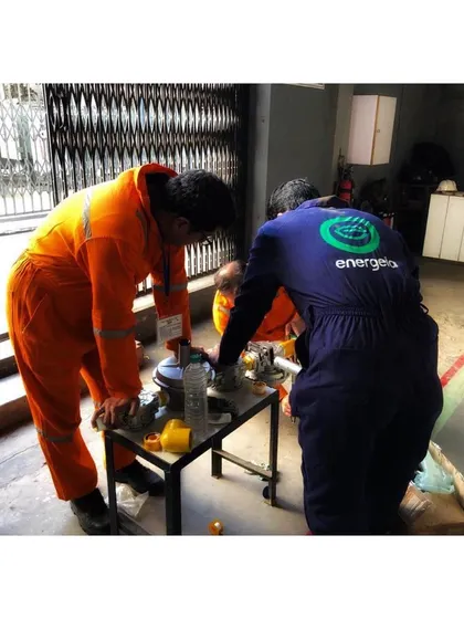 Two of our engineers work together on a piece of equipment on the factory floor. This image captures the hands on, collaborative nature of our on site implementation process.