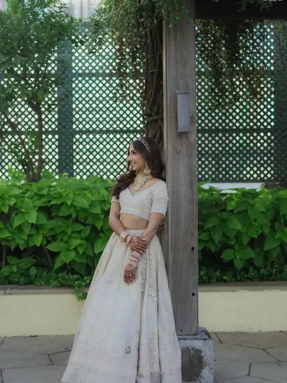 A full-length shot of Sheena's elegant ivory ensemble. The overall look is traditional yet modern and fresh.