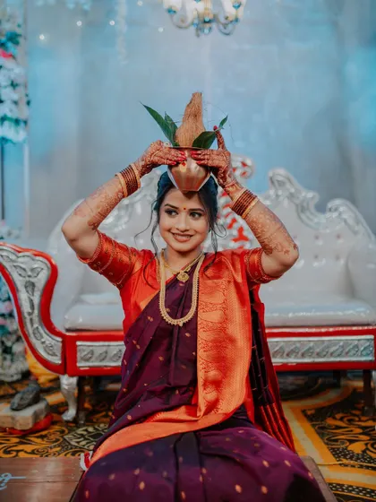 A portrait of the bride-to-be performing a traditional ritual during her engagement ceremony.