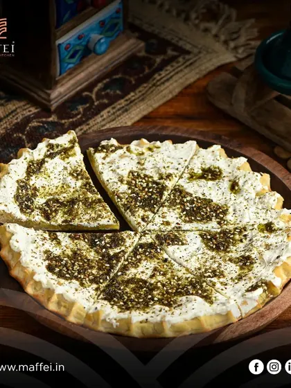Our Labneh with Za'atar Manakeesh offers a delightful contrast of creamy, tangy labneh and the earthy, herbal flavor of za'atar on a crispy, chewy crust.